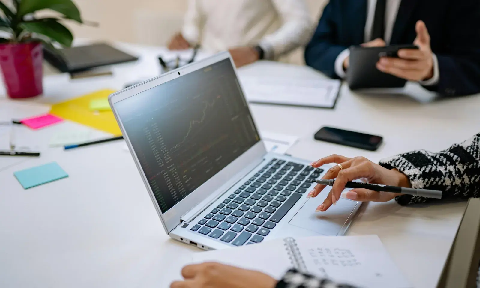 Business team reviewing financial data on a laptop